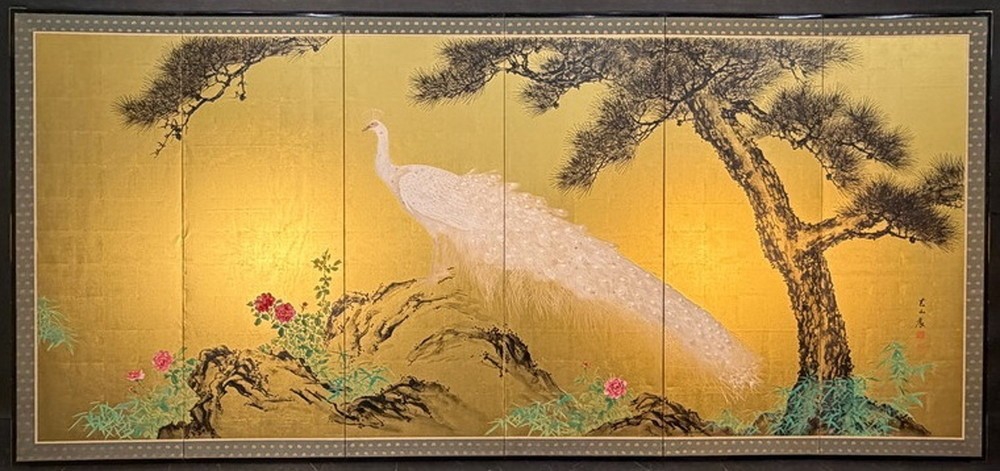 White peacock beneath pine branches on a gold-ground Japanese folding screen